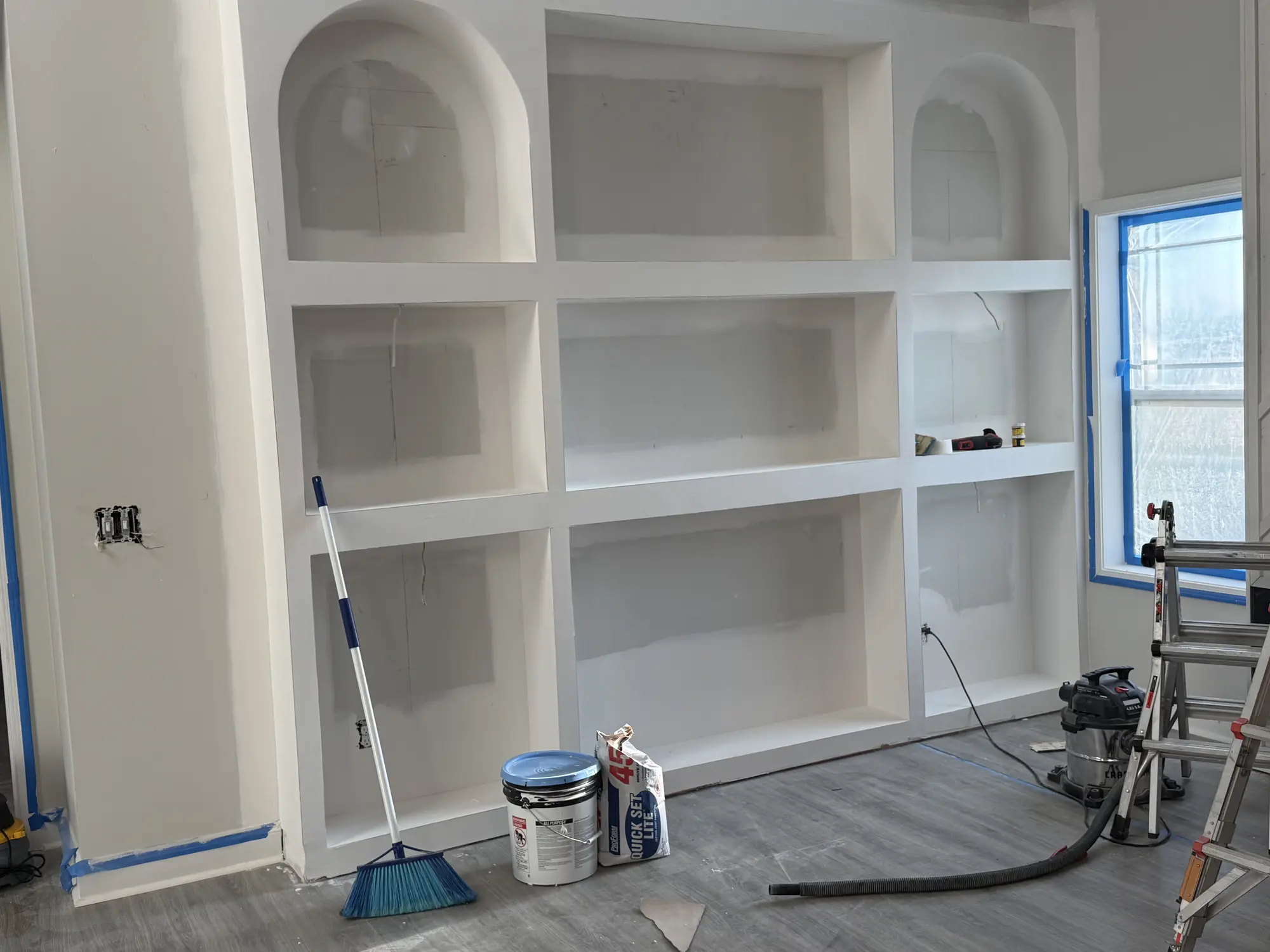 Custom built-in shelving painted white, finished by Obsidianwise