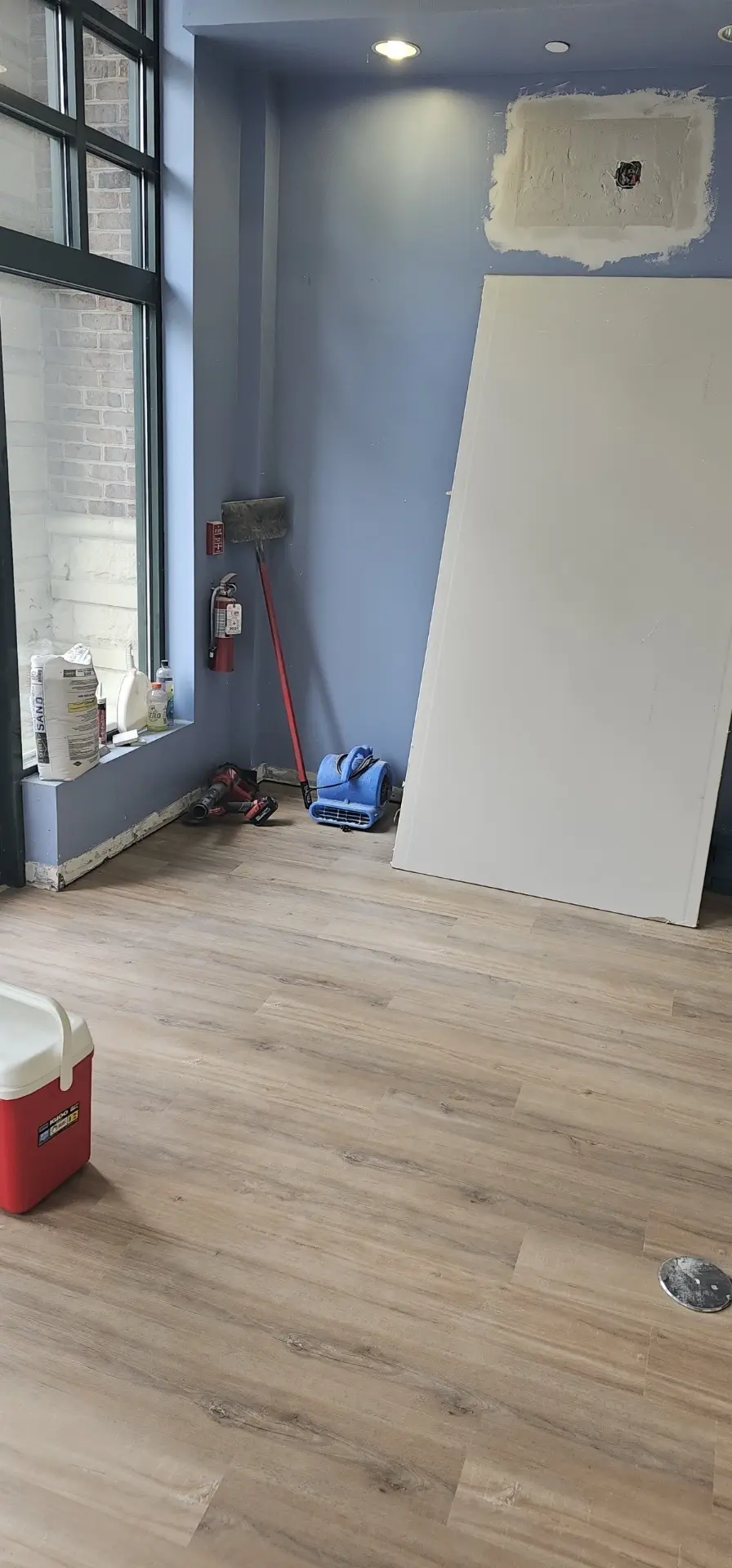 Commercial suite with blue walls and new vinyl plank flooring