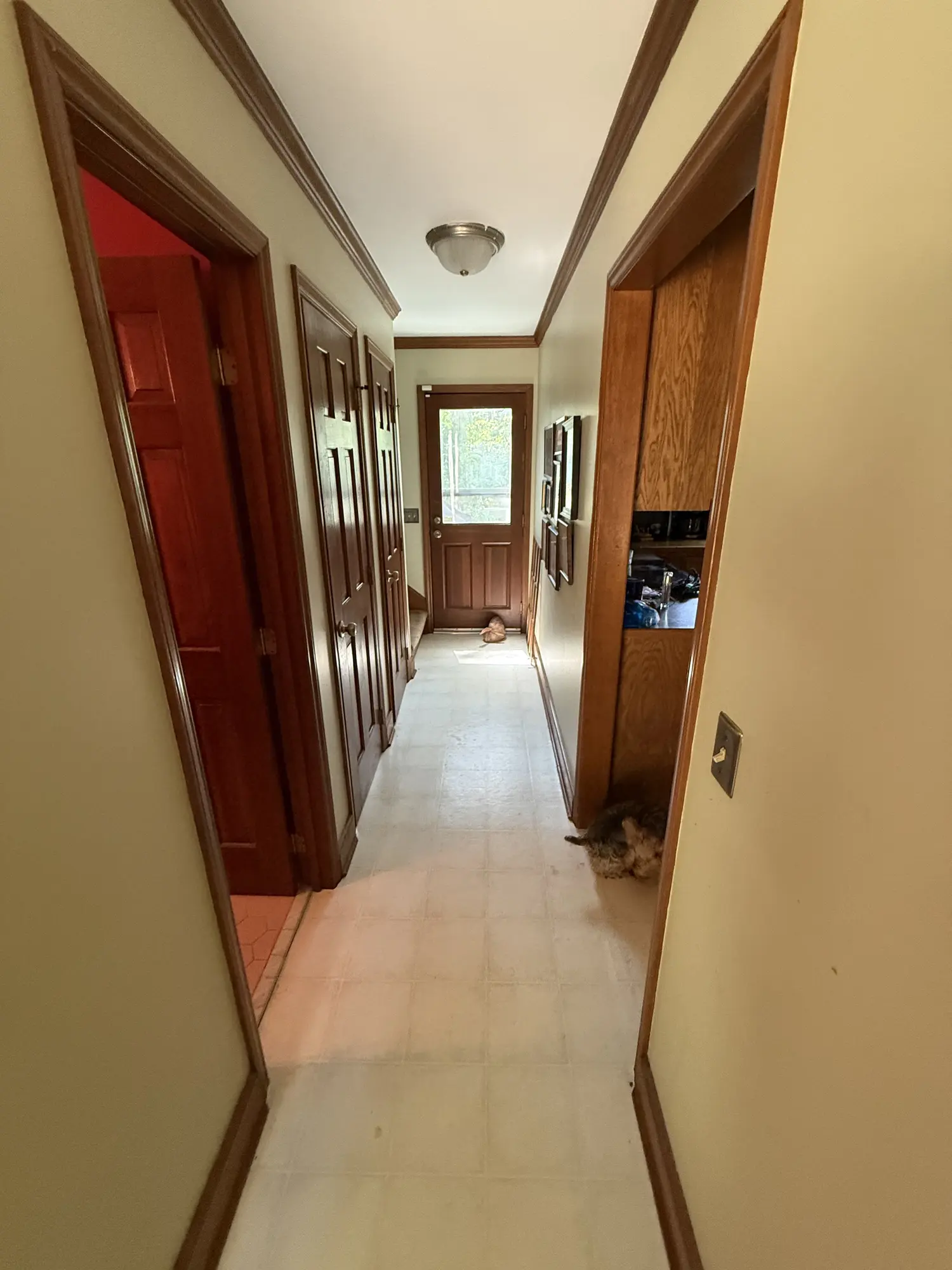 Hallway with old vinyl floor before remodel