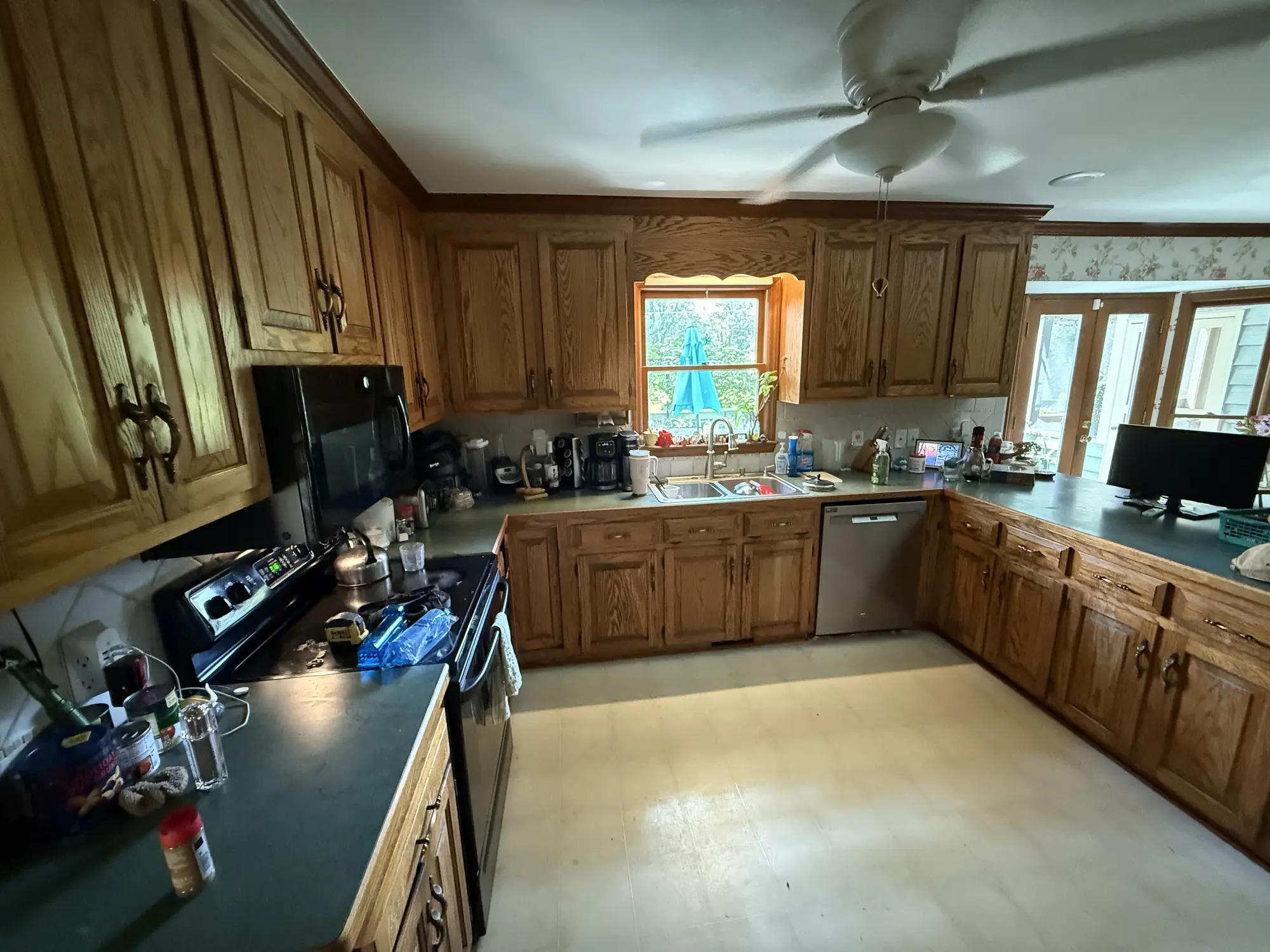 Oak kitchen cabinets and dark counters before remodel