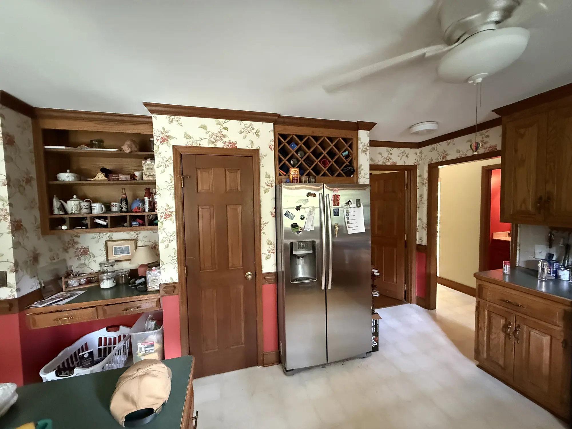 Kitchen fridge wall and pantry before remodel