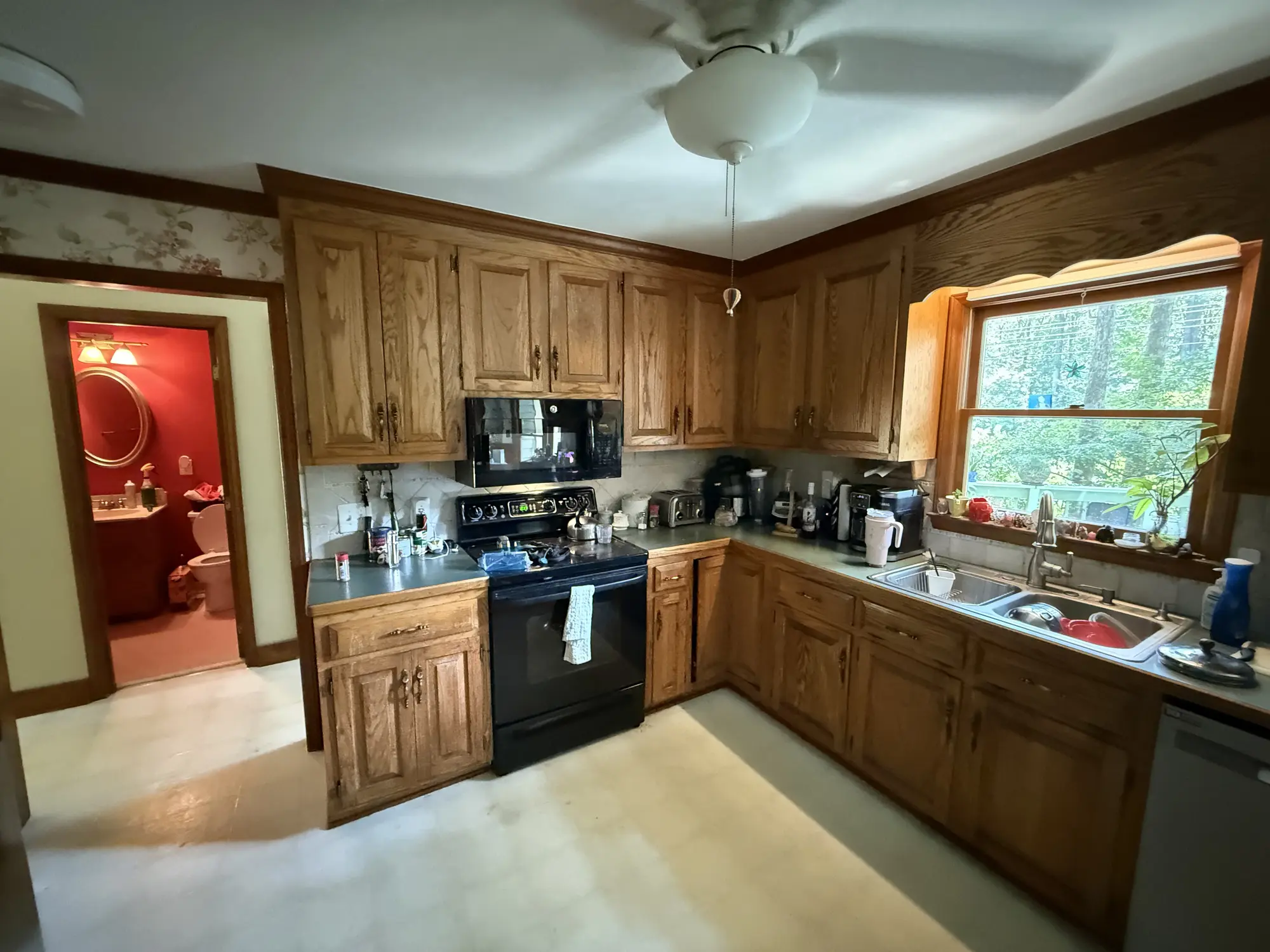 Kitchen range wall with dated cabinets before remodel