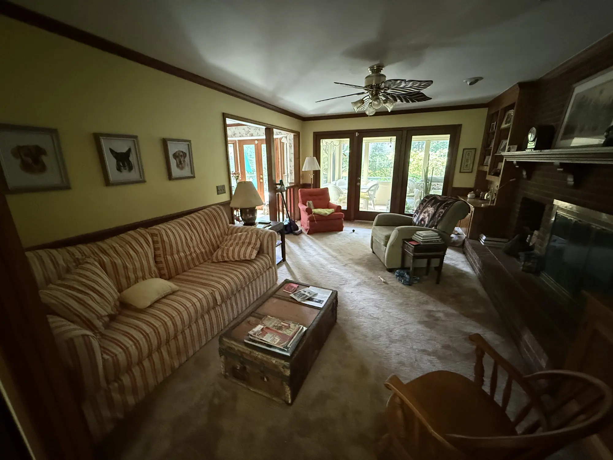 Living room with dated panelling before remodel