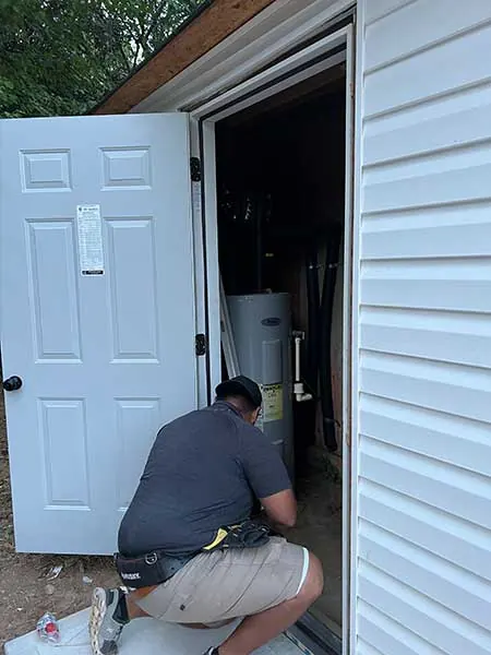 Exterior door being fitted with the water heater closet behind it