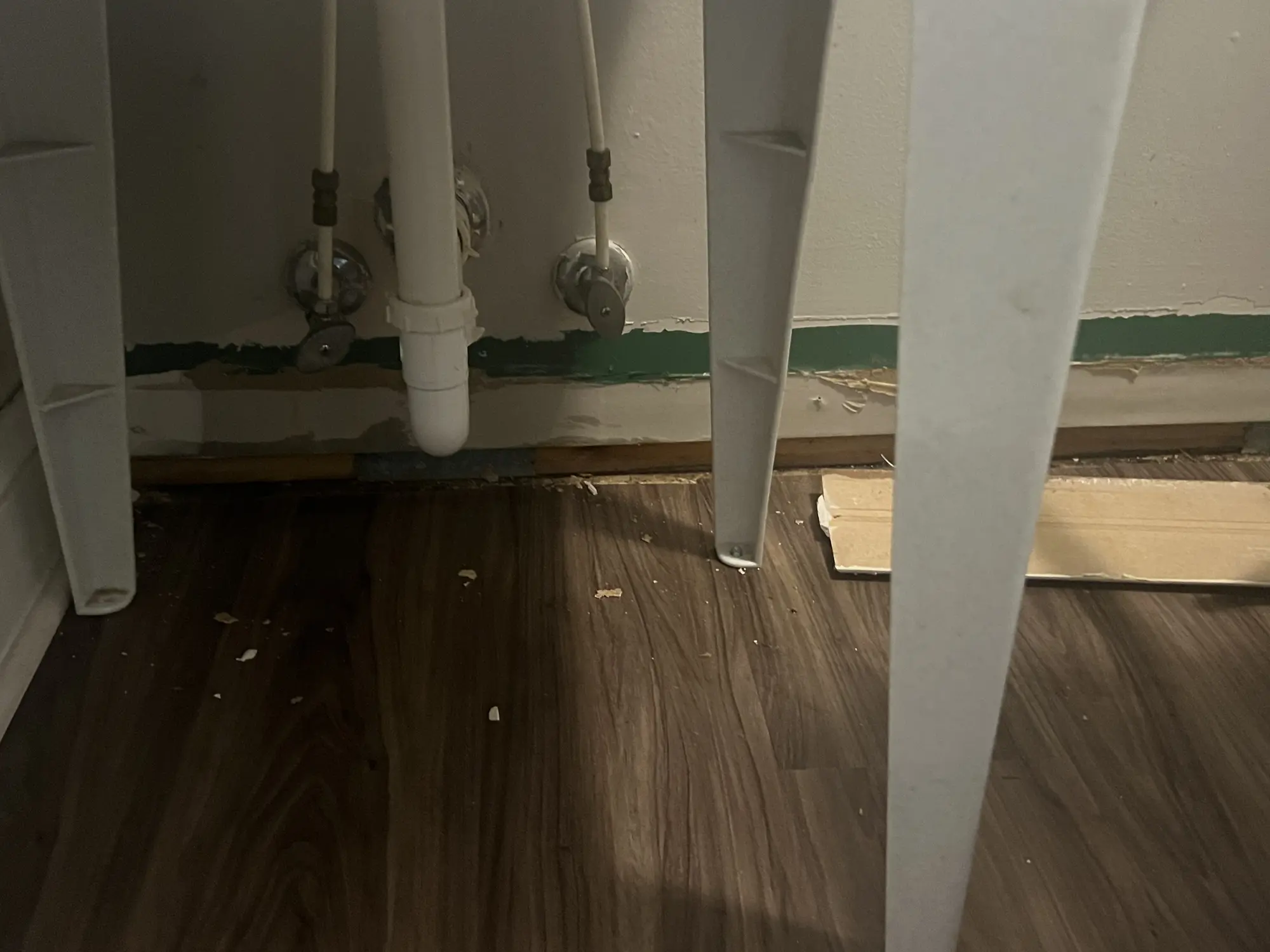 New vinyl plank flooring laid after a plumbing wall repair