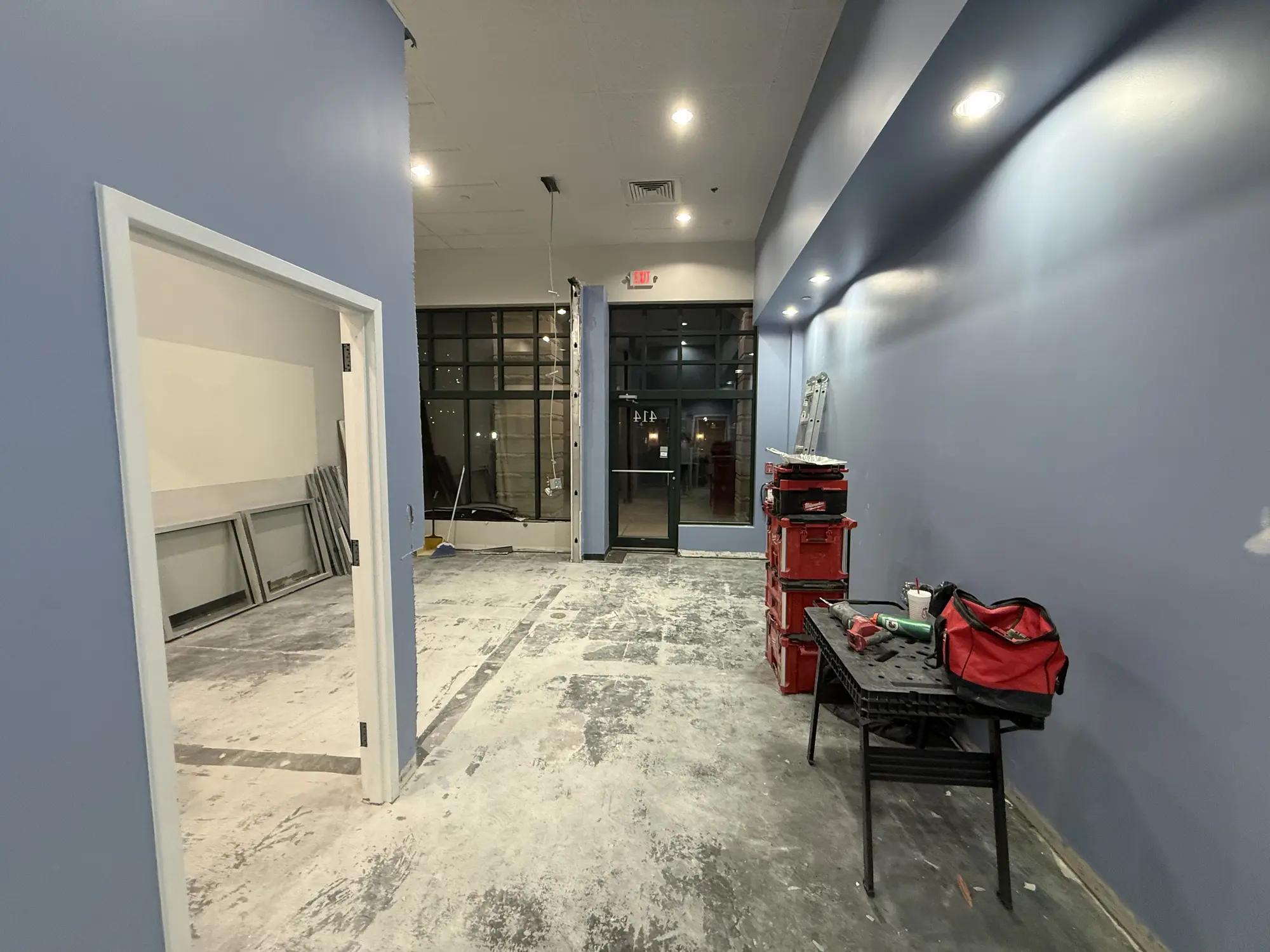 Office hallway during buildout with fresh paint on the walls