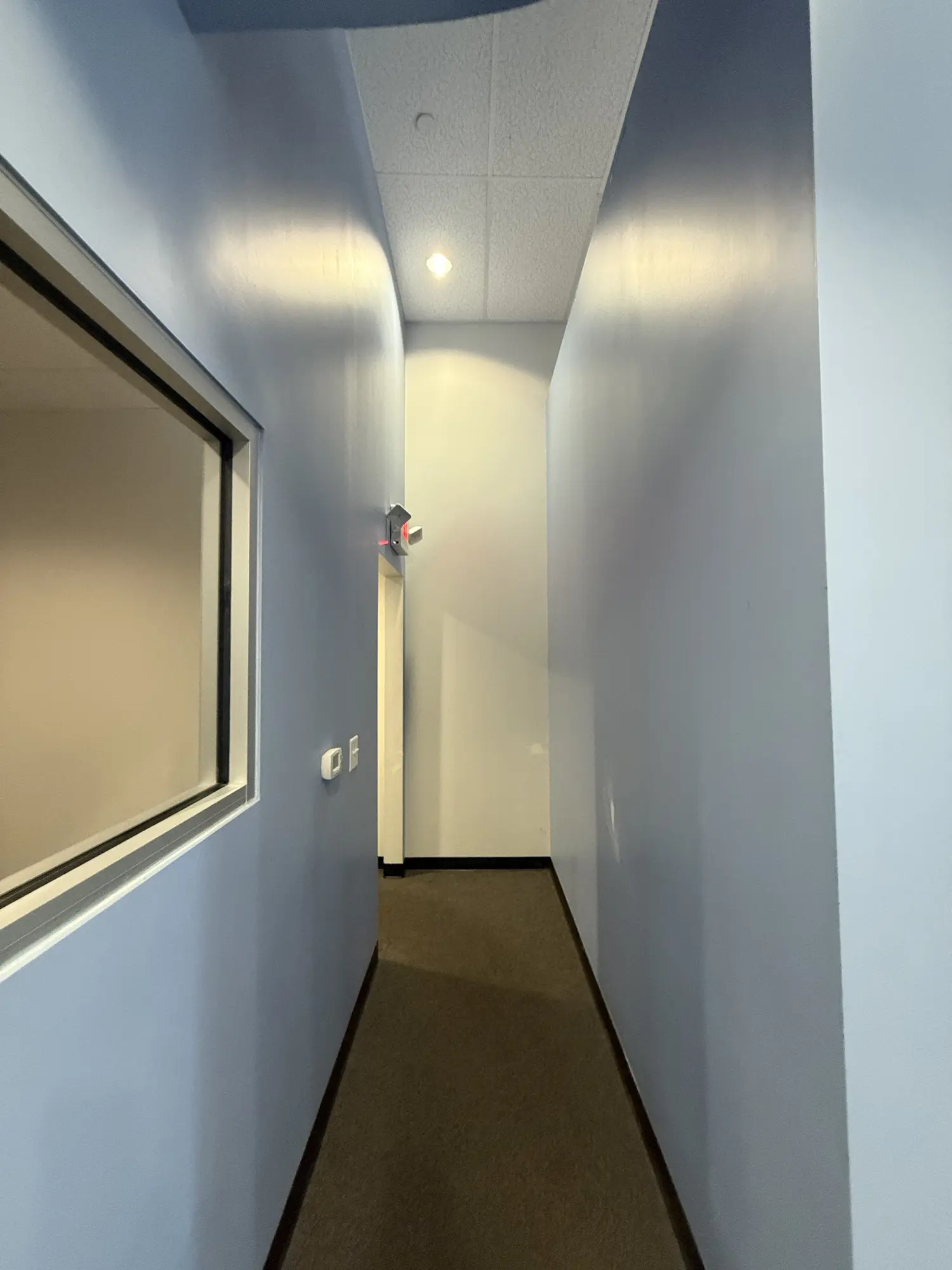 Narrow office hallway painted with a blue accent wall