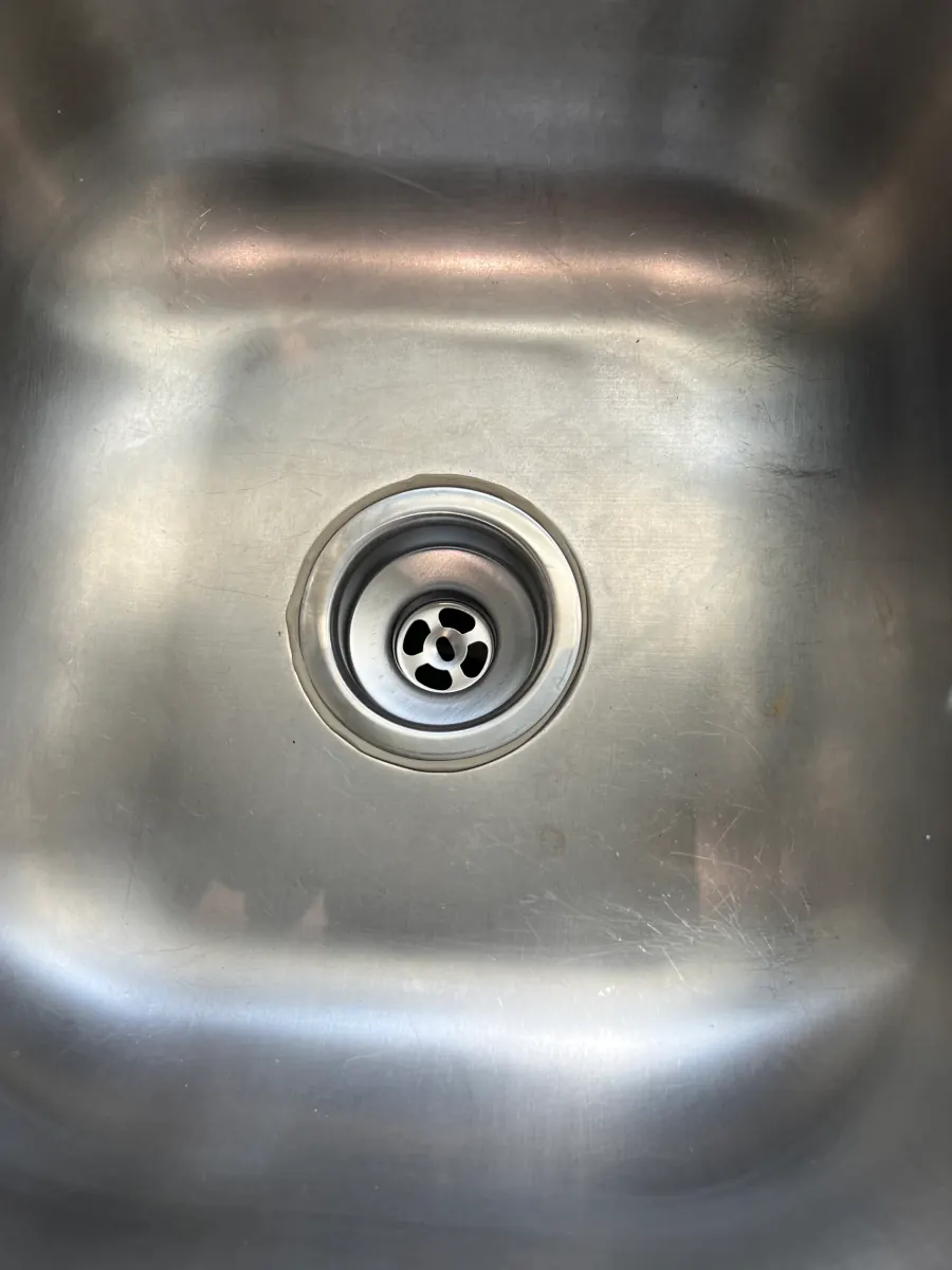 Stainless sink with a new drain assembly installed