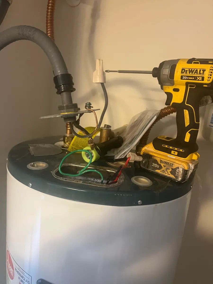 Water heater mid replacement with new fittings being made up