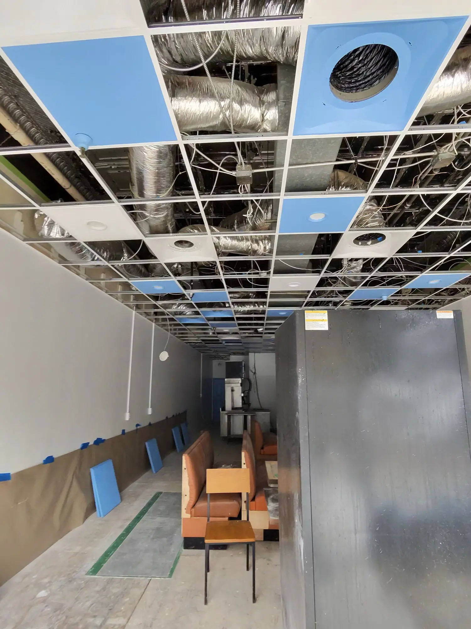 Restaurant ceiling grid opened up with ductwork exposed during renovation