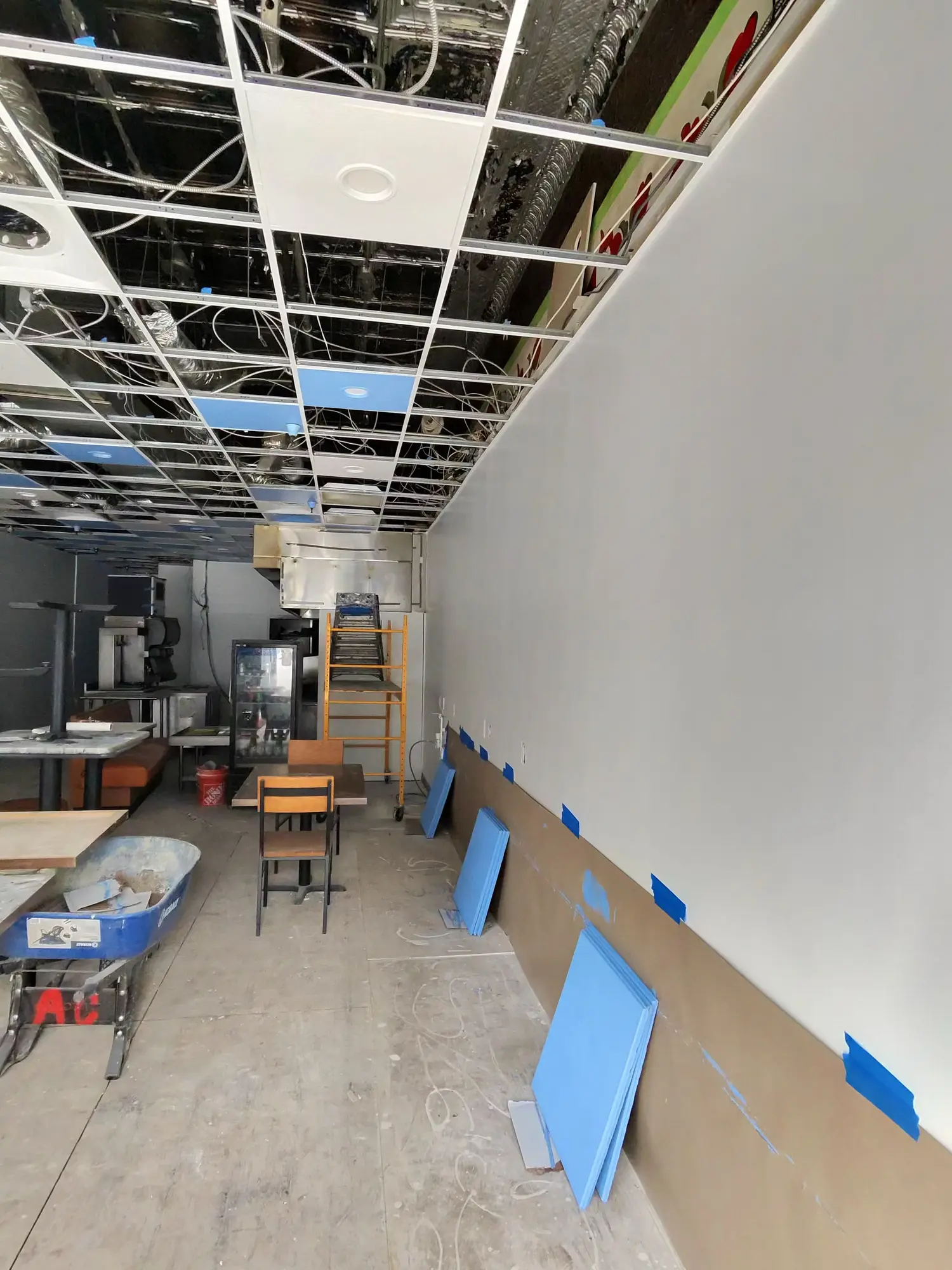 Restaurant dining room with walls prepped and protected during renovation