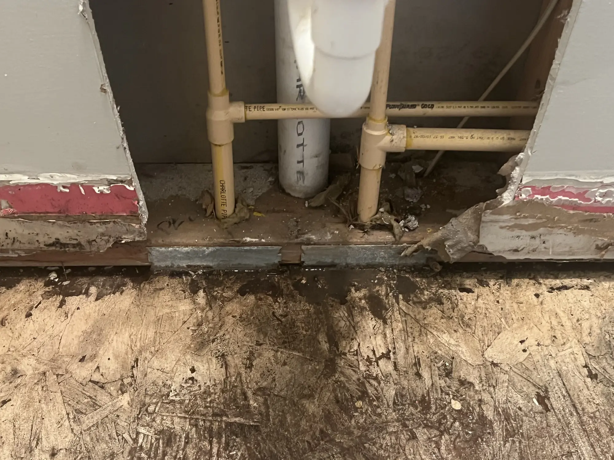 Water damaged wall base opened up around supply lines before repair