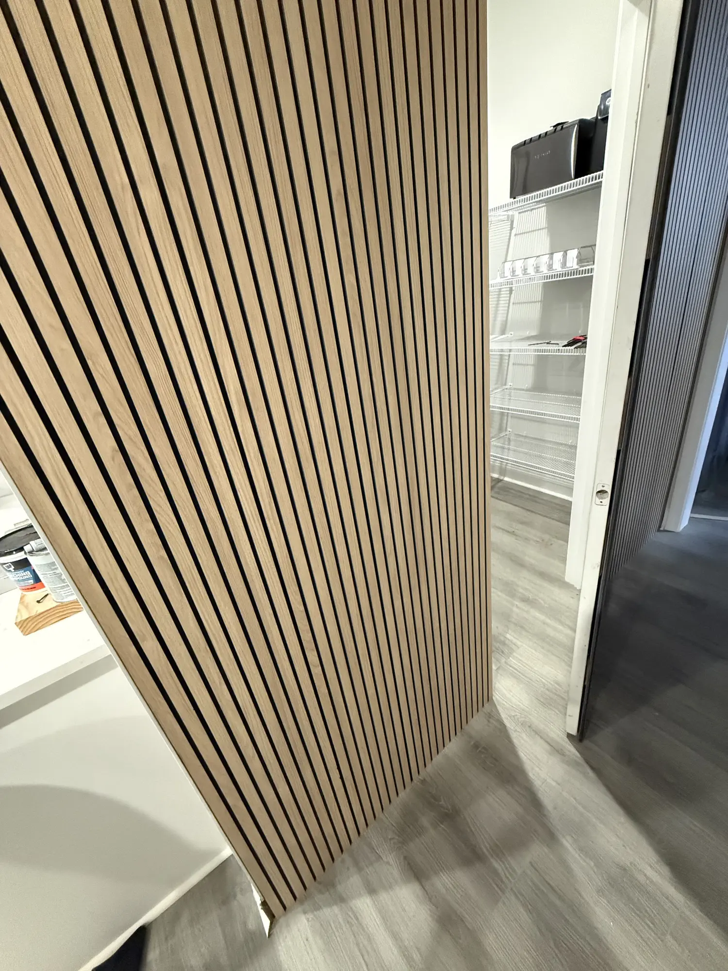 Detail of a wood slat wall panel meeting the door casing